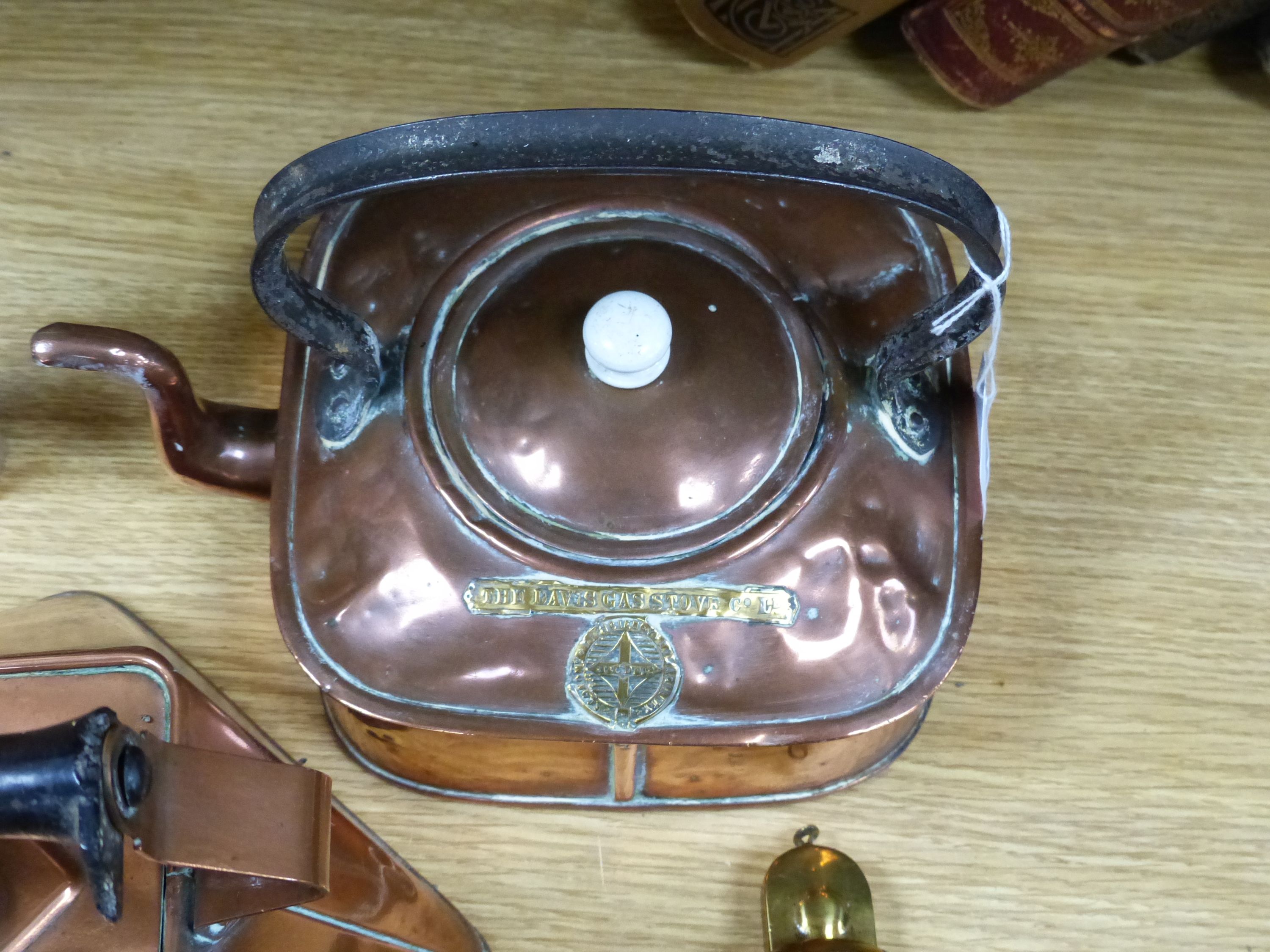 Two copper kettles, a beer slipper, iron ladle and a bull's eye lens